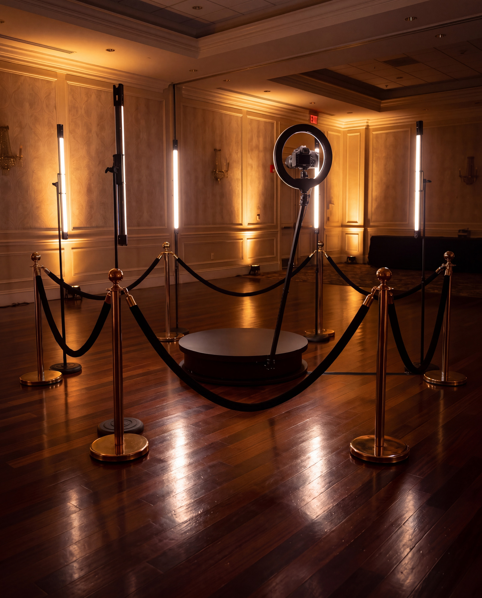 The 360 video booth set up with gold stanchions in a ballroom before guests arrive